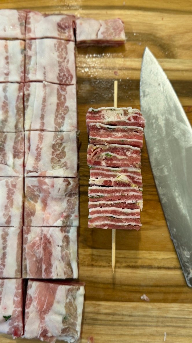 Skewers being built on a cutting board