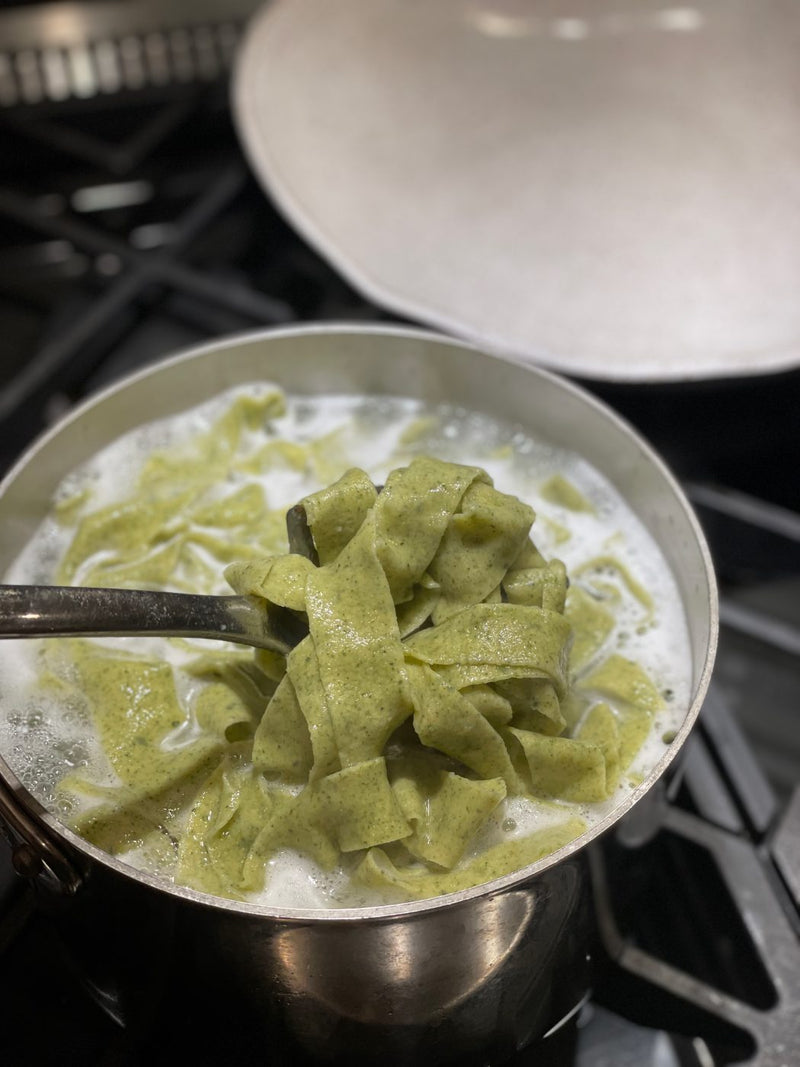 Fettuccine going into the pot