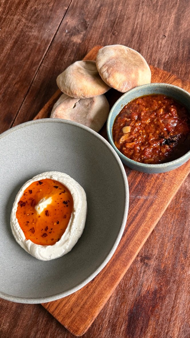 Whipped feta with chili oil, matbucha, and bread